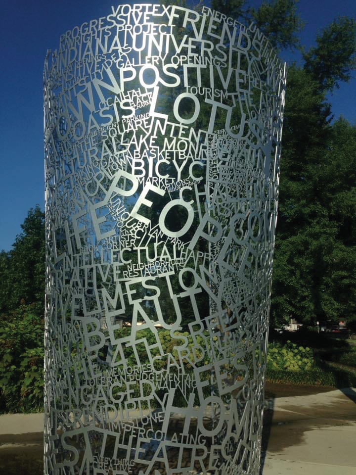 Photo of column sculpture, made of steel with laser cut words