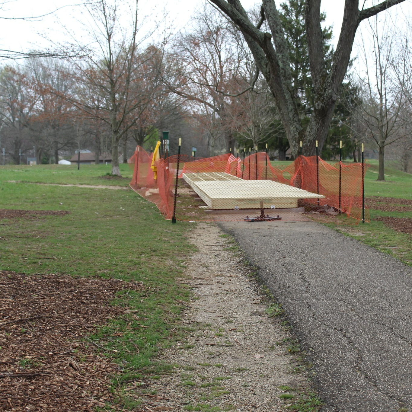 Photo of a new, elevated lumber boardwalk on the asphalt path at Bryan Park.