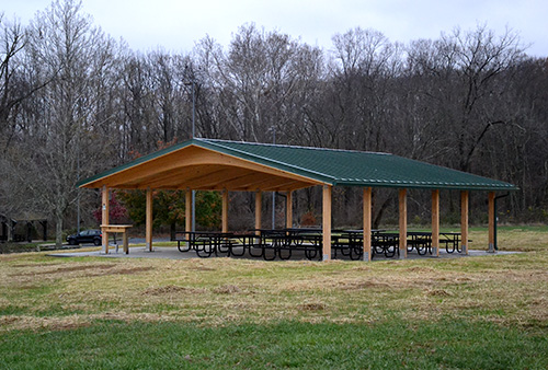 Group Shelter at RCA Community Park, with open sides and a green metal roof. Built in 2024.