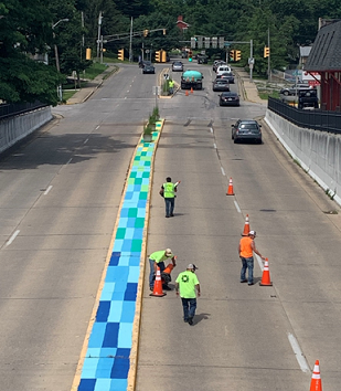 Repainting of the median and curb by crews on W. 3rd Street in June of 2019