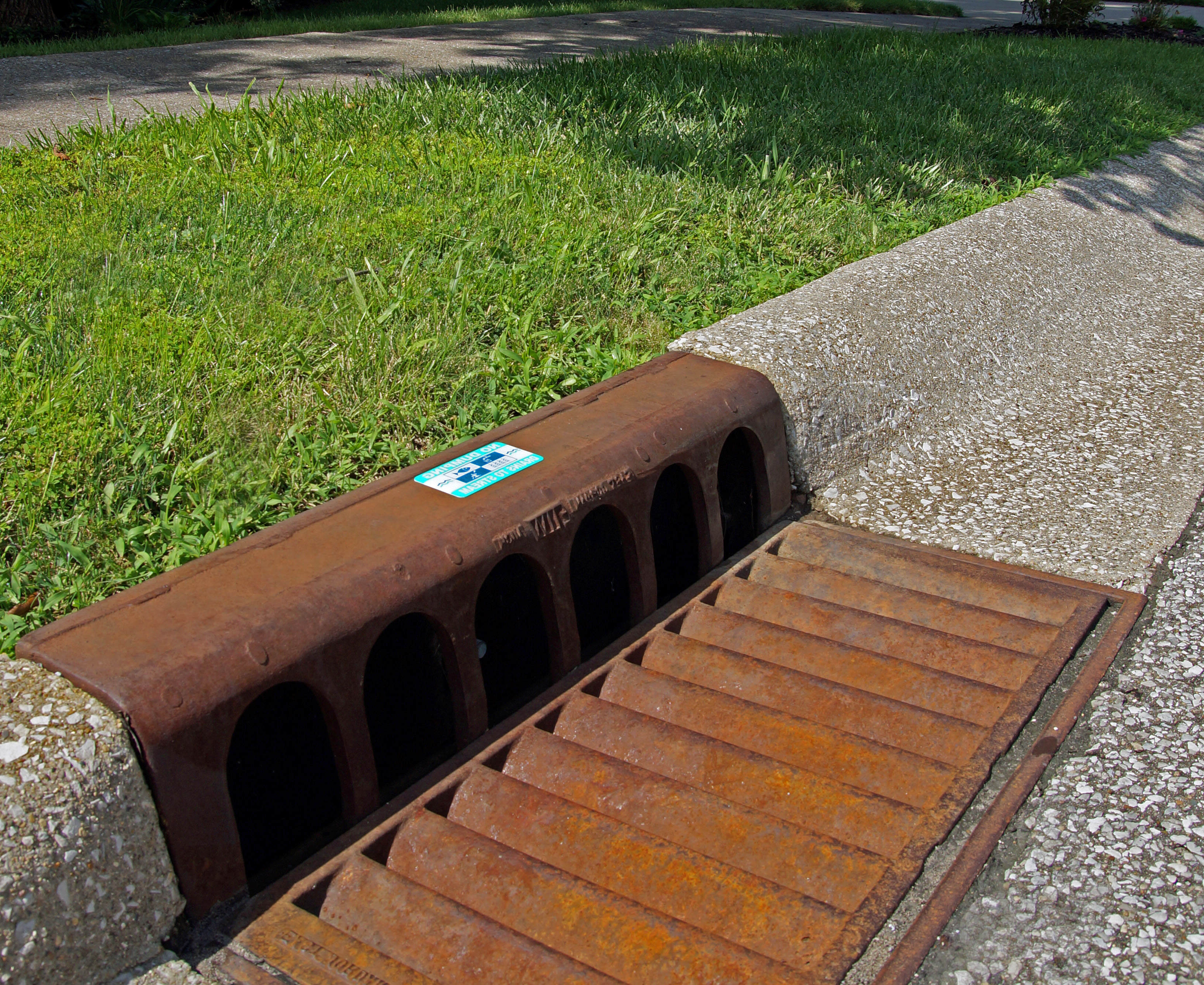 A storm drain marker on a storm drain