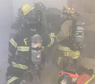 Picture of firefighters in smokey situation wearing masks.
