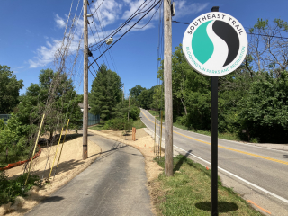 Photo of Southeast Trail sign and paved trail.