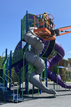 Parks staff repair the slide at Crestmont Park