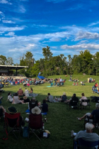Switchyard Park main performance stage and lawn with crowd during a live show by The Dynamics
